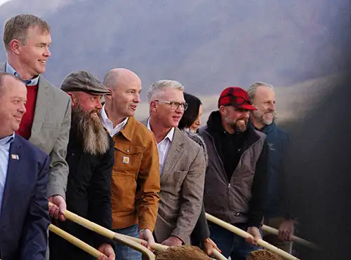 Governor Cox shoveling with a group of men